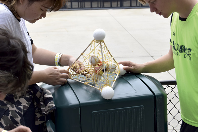 Maryland high school students create a device to keep a raw egg intact during the Egg Drop Competition at Six Flags Physics Day. Photos by Matt Payne.