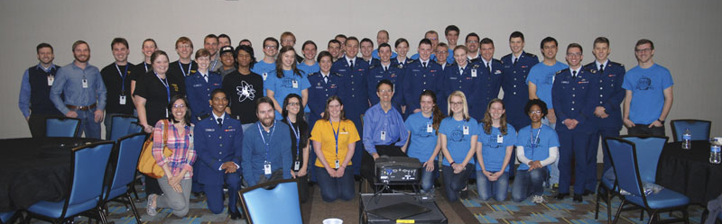 Students from the United States Air Force Academy, Colorado School of Mines, Colorado Mesa University, University of Colorado Denver, Metropolitan State University of Denver, and University of Wyoming pose with Nobel laureate Eric Cornell.