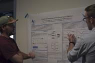 Air Force Academy student Donald Sakowicz (right) presents his research poster.