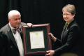 Previous recipient Karen Williams (right), East Central University (OK), presents Steve Feller, Coe College (IA), with the Sigma Pi Sigma Worth Seagondollar Award at the 2012 Quadrennial Physics Congress in Orlando, FL, November 10, 2012.