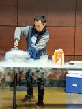 A student helps make liquid nitrogen ice cream.